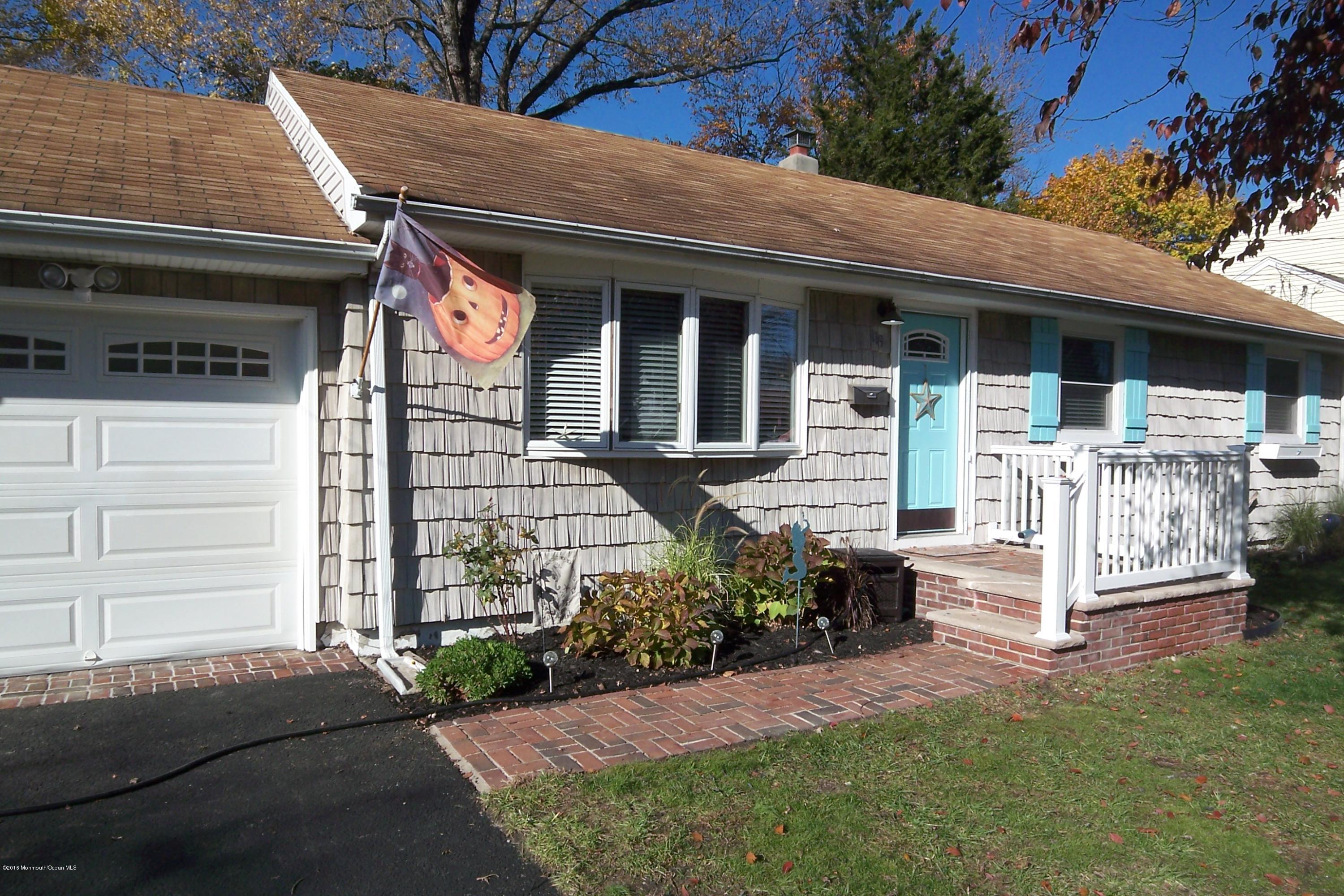 119 Meadowbrook Road Spring Lake Heights, NJ 07762 - Photo 1 of 24 a front view of a house with a yard