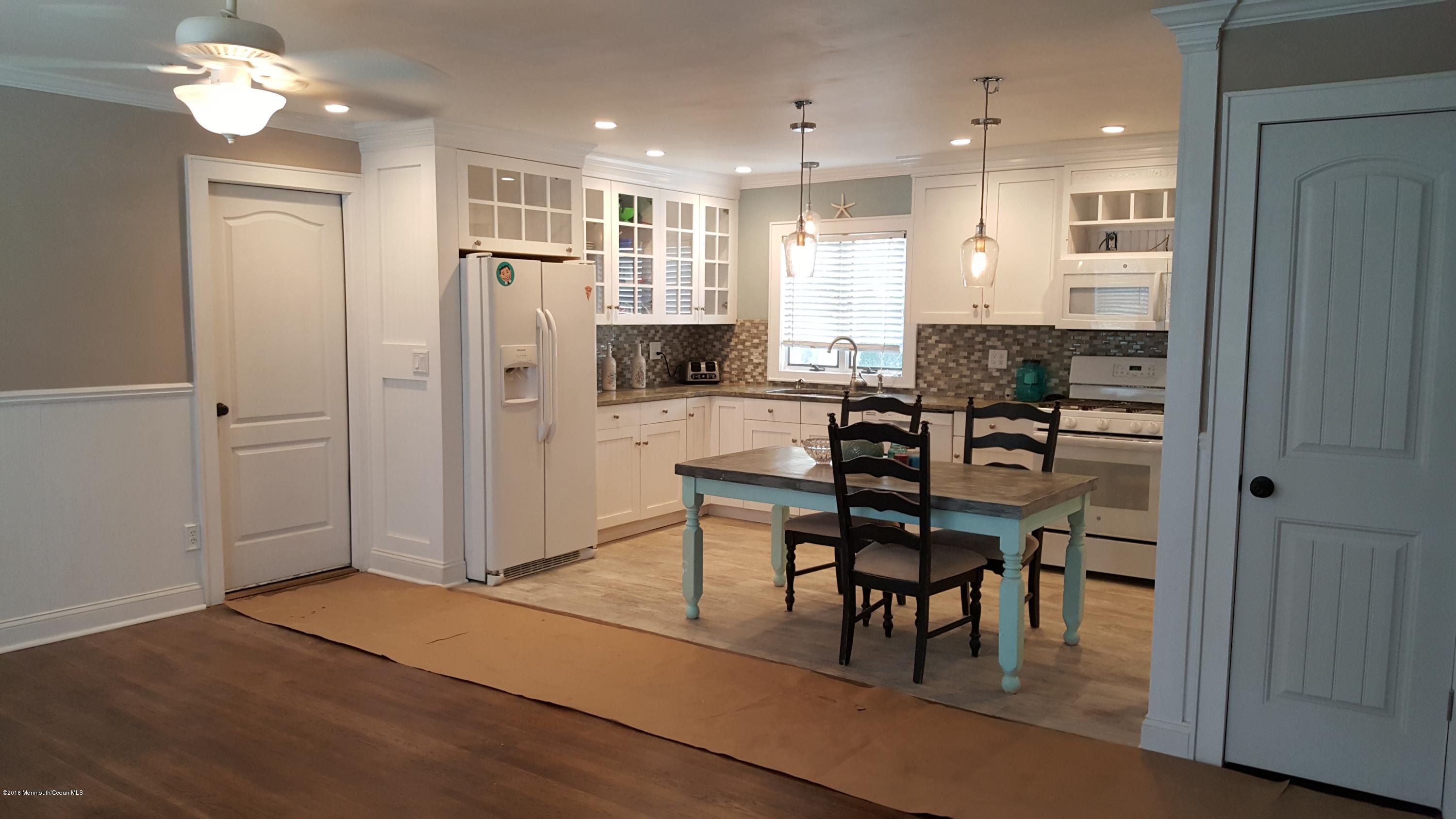 119 Meadowbrook Road Spring Lake Heights, NJ 07762 - Photo 4 of 24 a view of a dining room with furniture and wooden floor