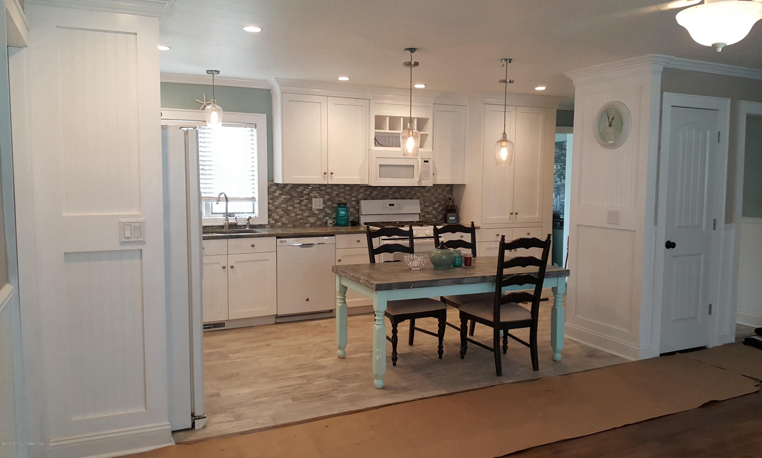 119 Meadowbrook Road Spring Lake Heights, NJ 07762 - Photo 5 of 24 a kitchen with kitchen island white cabinets and stainless steel appliances