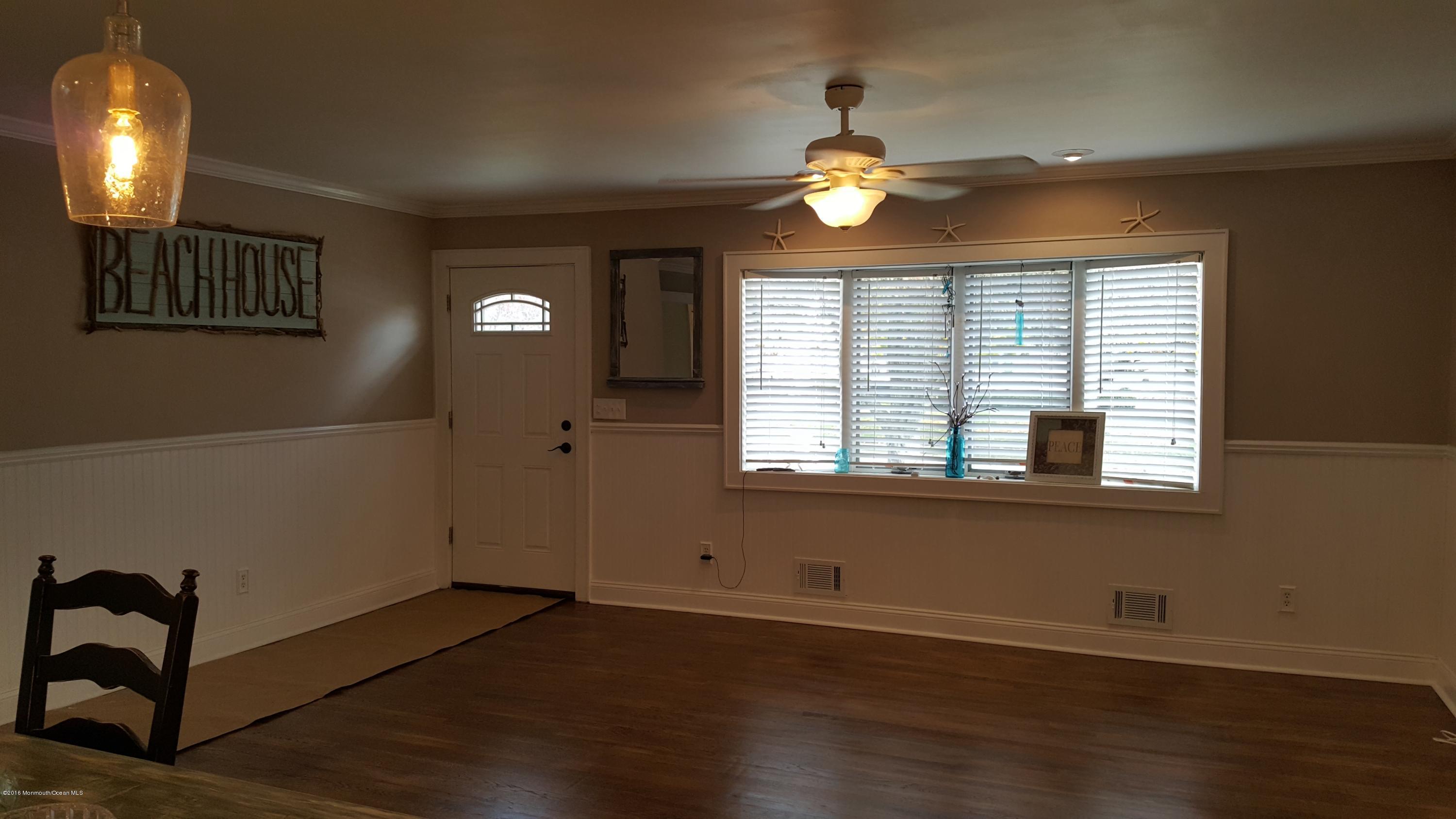 119 Meadowbrook Road Spring Lake Heights, NJ 07762 - Photo 7 of 24 an empty room with wooden floor and windows