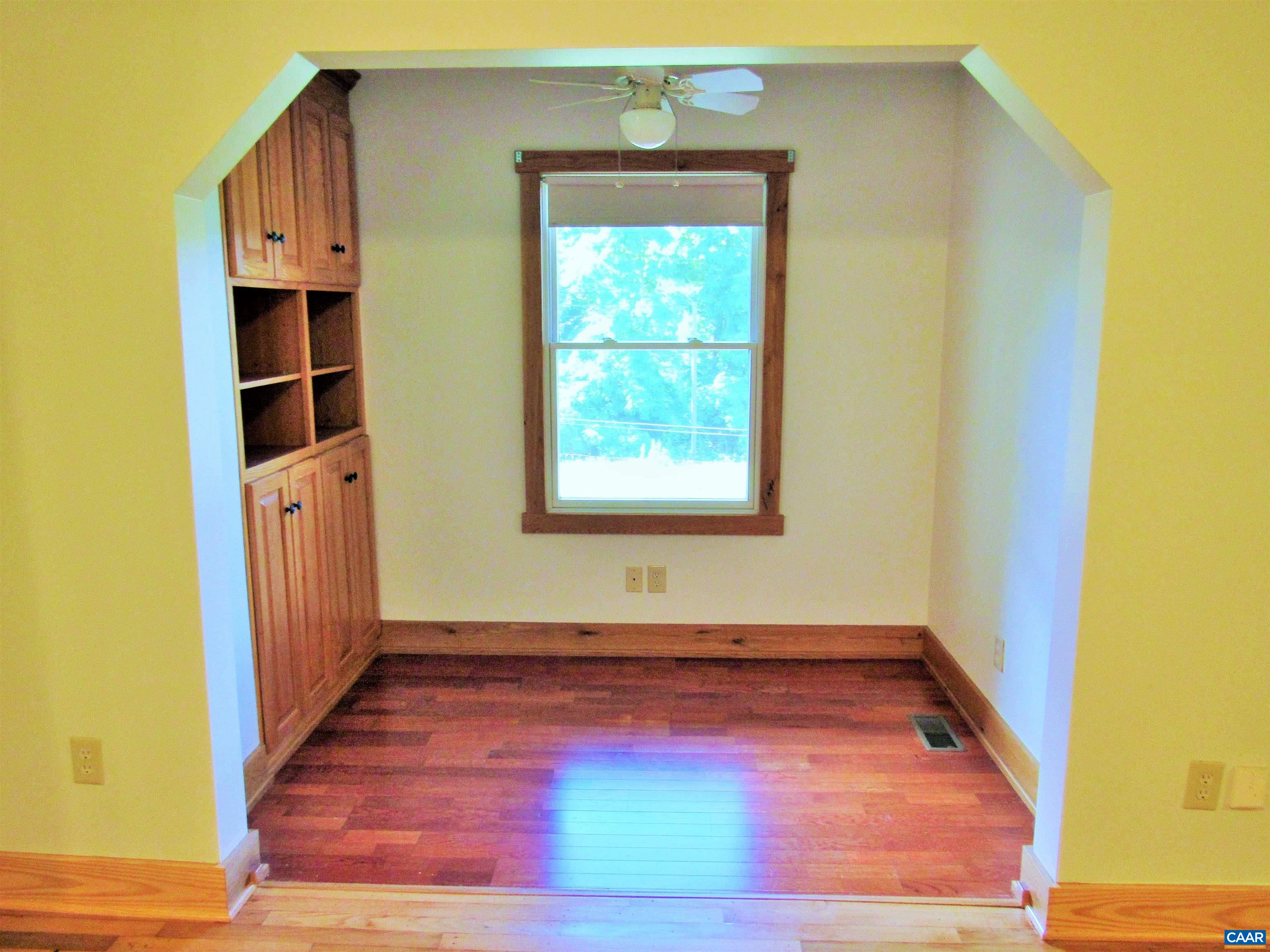 611 Hartless Road Amherst, VA 24521 - Photo 15 of 51 an empty room with wooden floor and cabinet