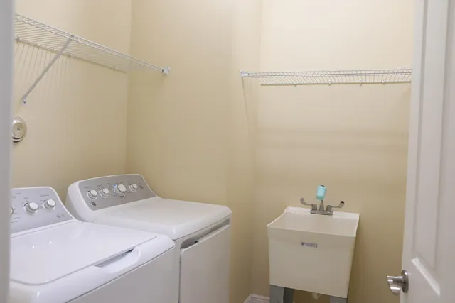 a white toilet sitting next to a white wall