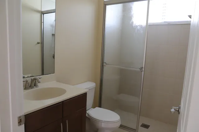 a living room with stainless steel appliances kitchen island granite countertop a refrigerator a sink and dishwasher