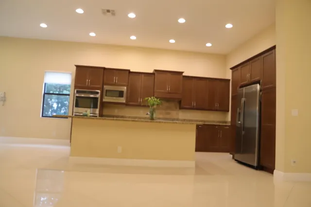 a living room with kitchen island furniture and a large window