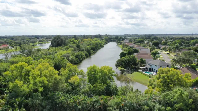 an aerial view of a city with lots of residential buildings and lake view in back