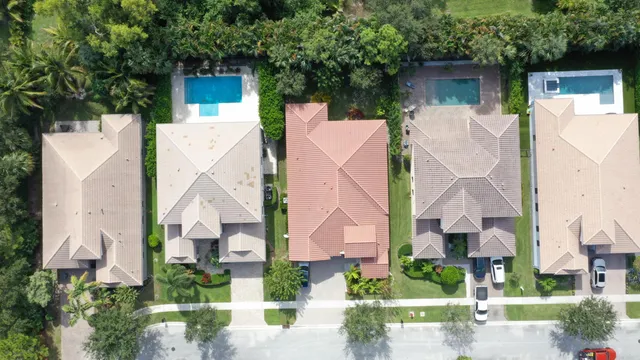 an aerial view of a house with garden space and street view