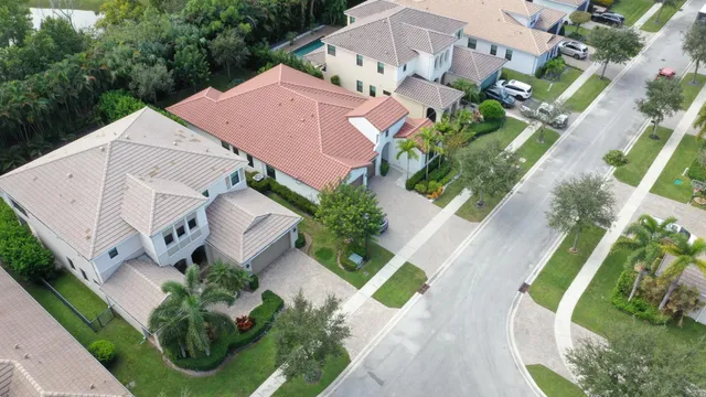 an aerial view of residential house with outdoor space and trees all around