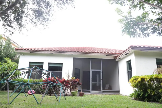 a front view of house with yard outdoor seating and green space