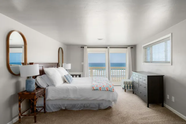 a bedroom with bed and a large window