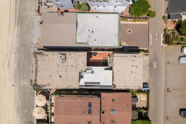 an aerial view of a kitchen with granite countertop white cabinets and a sink