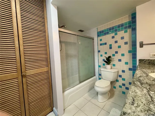 a bathroom with a toilet and a shower curtain