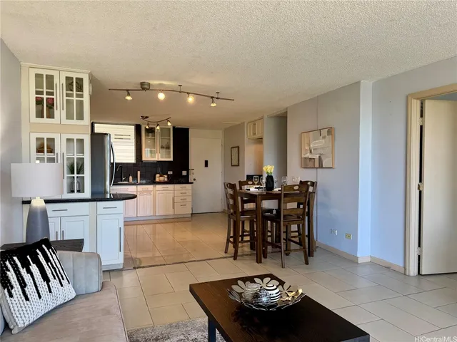 a living room with furniture and kitchen view