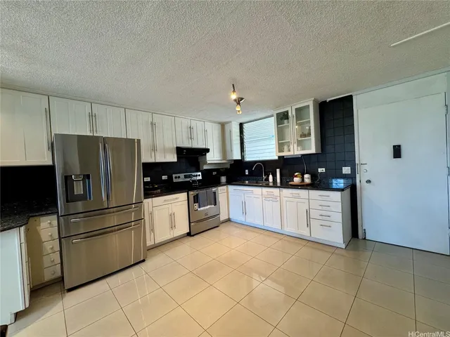 a kitchen with stainless steel appliances a refrigerator sink and microwave