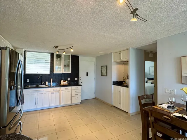 a kitchen with stainless steel appliances a refrigerator and a stove top oven