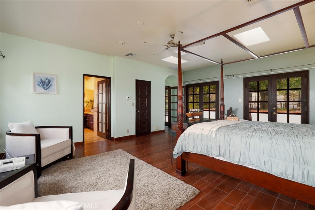 5818 Painter Avenue Whittier, CA 90601 - Photo 41 of 53 a spacious bedroom with a bed a bookshelf and a large window