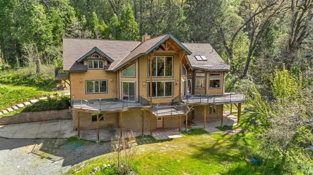 a aerial view of a house with swimming pool and sitting area