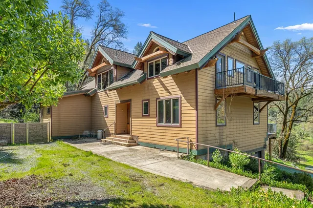 a bathroom with a tub and a large window