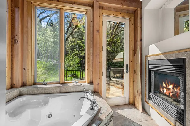 a bathroom with a granite countertop sink and a large mirror