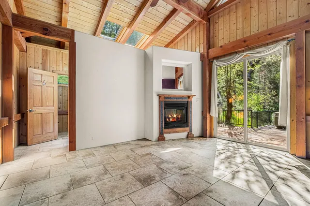 a large white kitchen with kitchen island granite countertop a large window and a counter