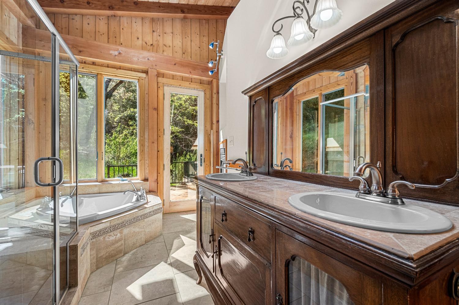 4271 Marshall Road Georgetown, CA 95634 - Photo 25 of 70 a bathroom with a granite countertop sink and a large mirror