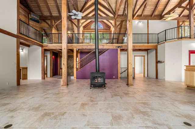 a view of a balcony with wooden floor and fence