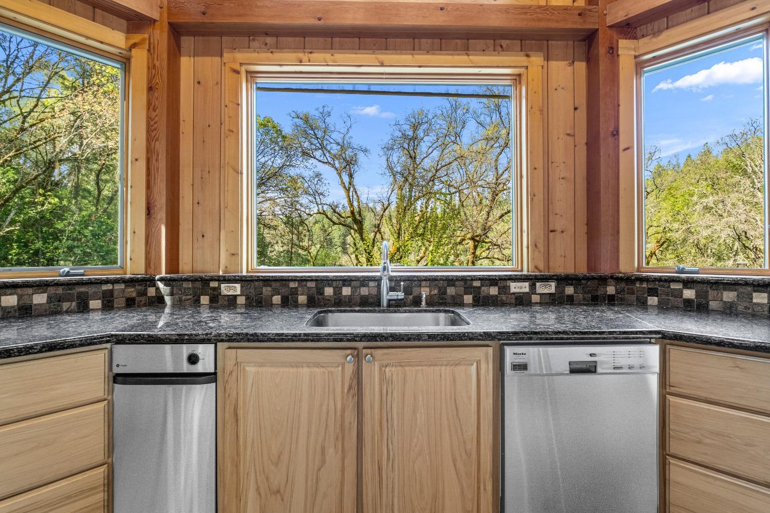 4271 Marshall Road Georgetown, CA 95634 - Photo 36 of 70 a bathroom with a granite countertop sink and a large mirror