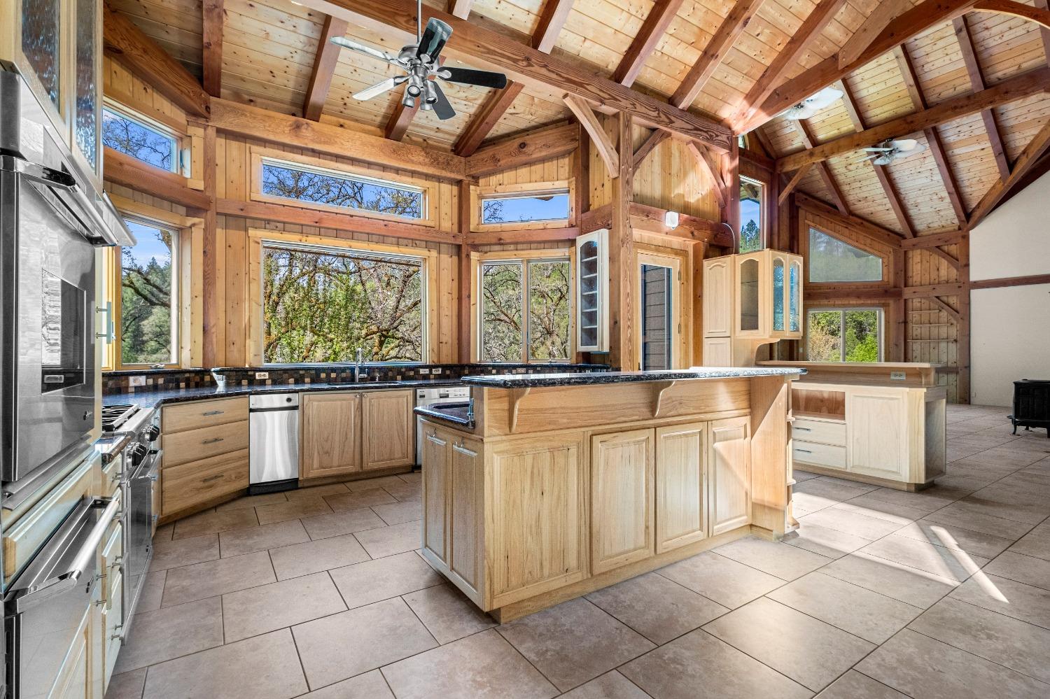 4271 Marshall Road Georgetown, CA 95634 - Photo 38 of 70 a large white kitchen with kitchen island granite countertop a large window and a counter