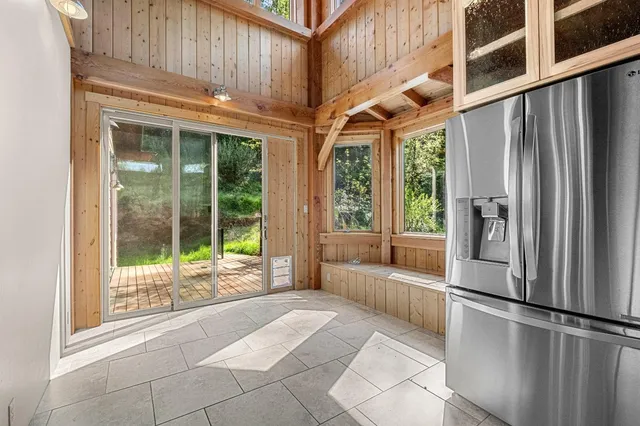 a view of a balcony with wooden floor and outdoor space