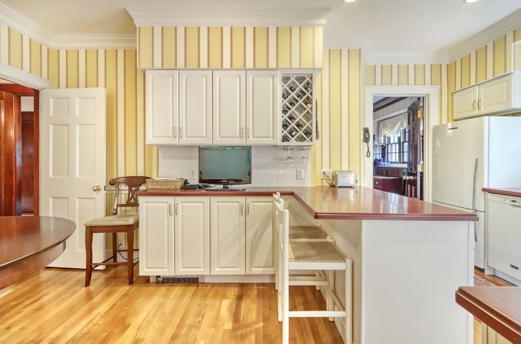 3 Sheffield Road Winchester, MA 01890 - Photo 17 of 42 a view of a kitchen with dining table and chairs