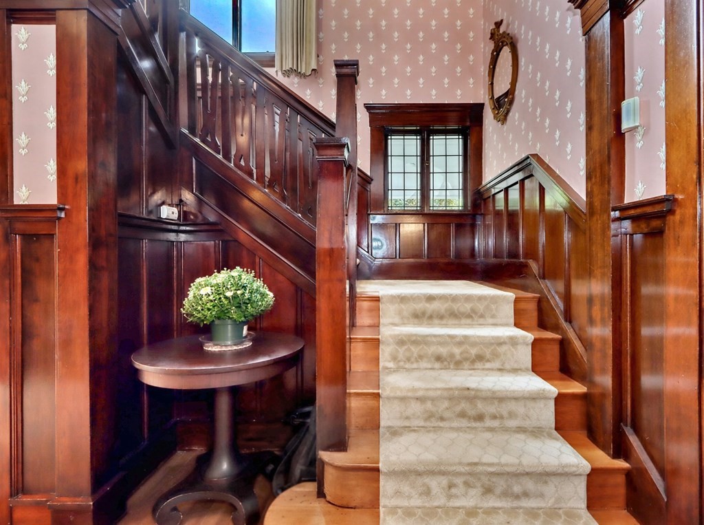 3 Sheffield Road Winchester, MA 01890 - Photo 20 of 42 a view of staircase with wooden floor and a potted plant