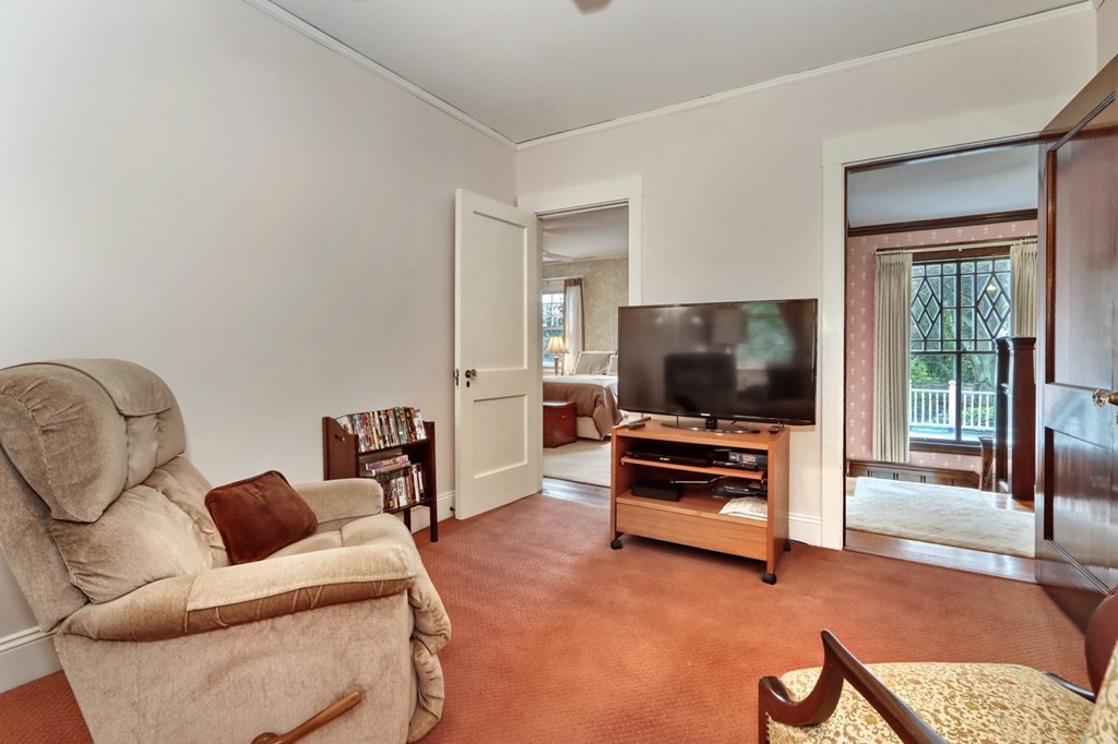 3 Sheffield Road Winchester, MA 01890 - Photo 23 of 42 a living room with furniture and a flat screen tv