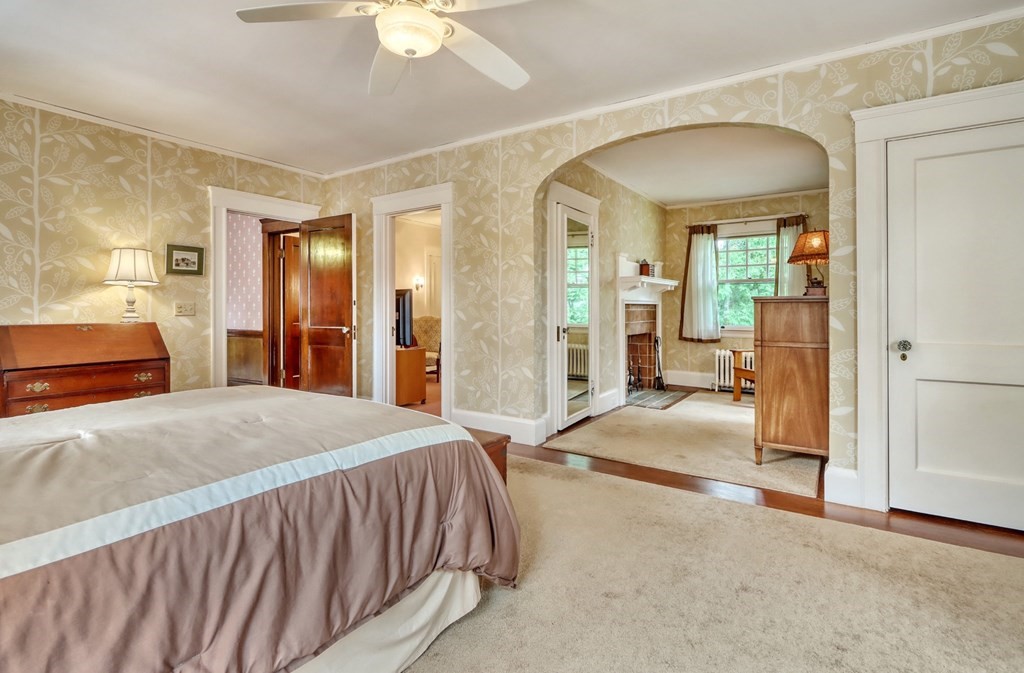 3 Sheffield Road Winchester, MA 01890 - Photo 25 of 42 a bedroom with a bed and a chandelier