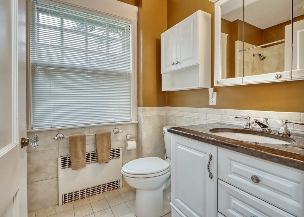 3 Sheffield Road Winchester, MA 01890 - Photo 27 of 42 a bathroom with a granite countertop sink toilet and mirror