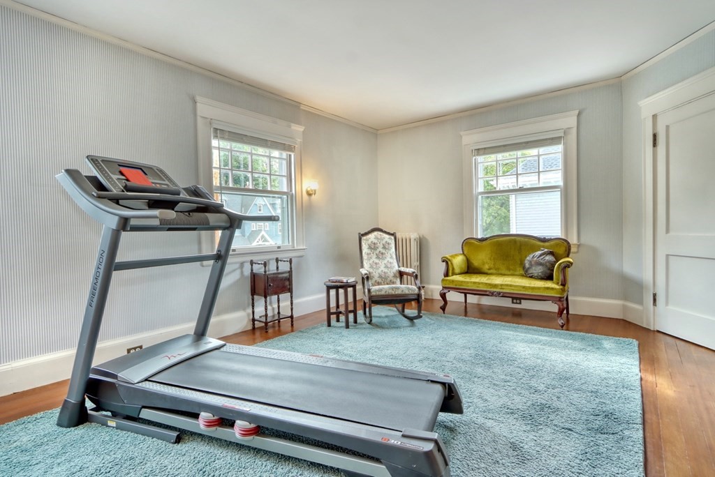 3 Sheffield Road Winchester, MA 01890 - Photo 29 of 42 a living room with furniture a window and gym equipment