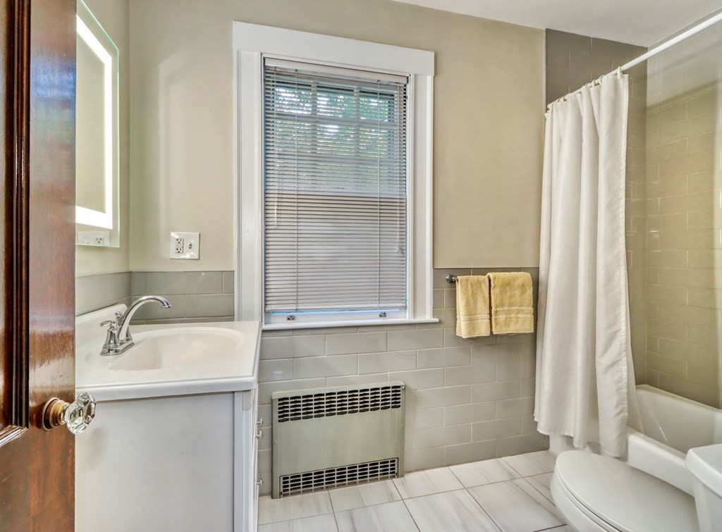 3 Sheffield Road Winchester, MA 01890 - Photo 33 of 42 a bathroom with a sink and a mirror