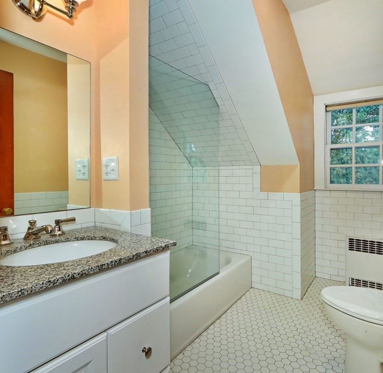 3 Sheffield Road Winchester, MA 01890 - Photo 36 of 42 a bathroom with a granite countertop bathtub sink vanity mirror and toilet