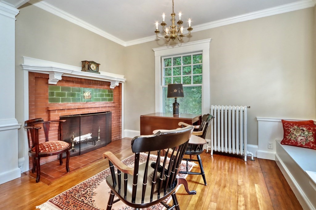 3 Sheffield Road Winchester, MA 01890 - Photo 9 of 42 a dining room with furniture a fireplace and wooden floor