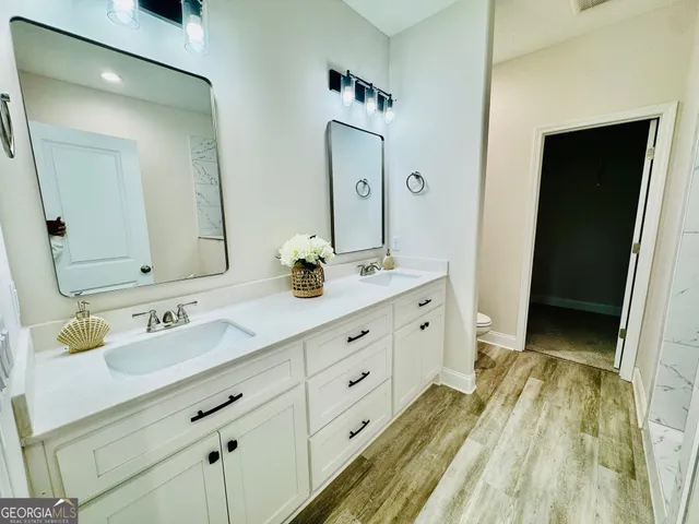 a bathroom with a double vanity sink and a mirror