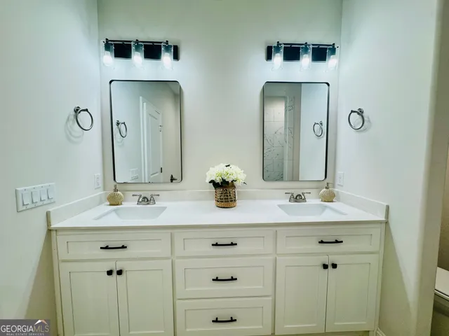 a bathroom with a double vanity sink and mirror