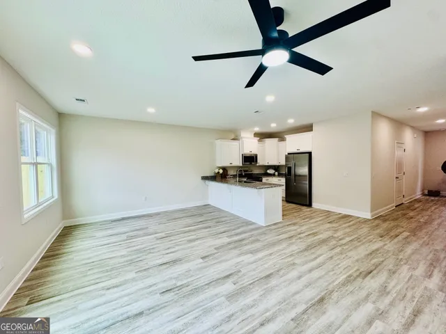 a view of kitchen with refrigerator microwave and stove
