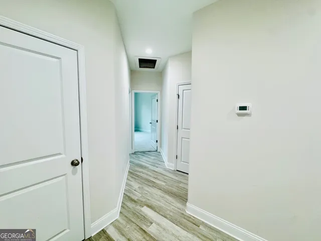 a view of a bathroom from a hallway