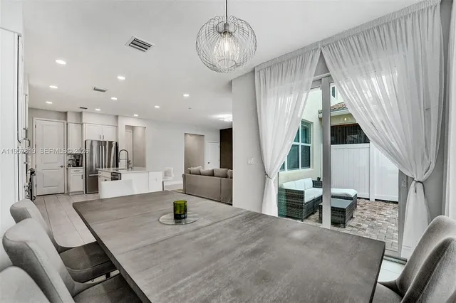 a kitchen with sink table and chairs