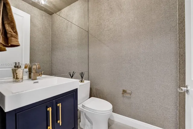 a bathroom with a sink a toilet and mirror