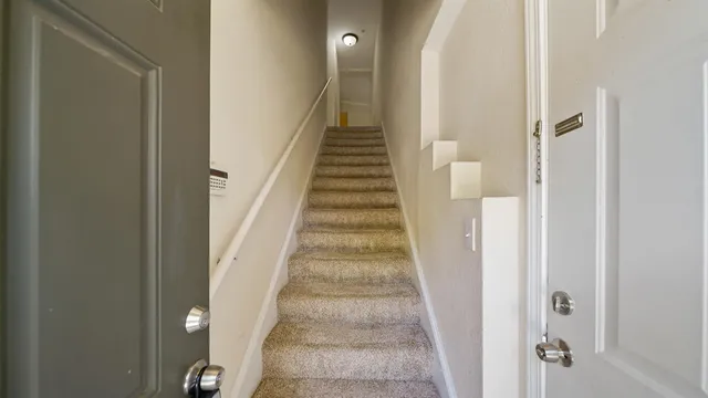 a view of a hallway with wooden floor and entryway