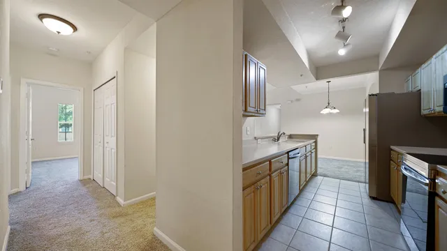 a kitchen with granite countertop a refrigerator and a sink