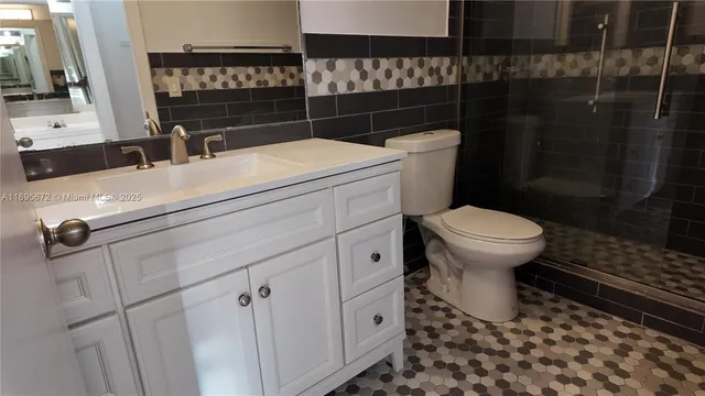 a bathroom with a sink toilet and shower