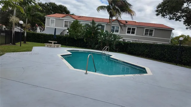 a swimming pool with outdoor seating and yard