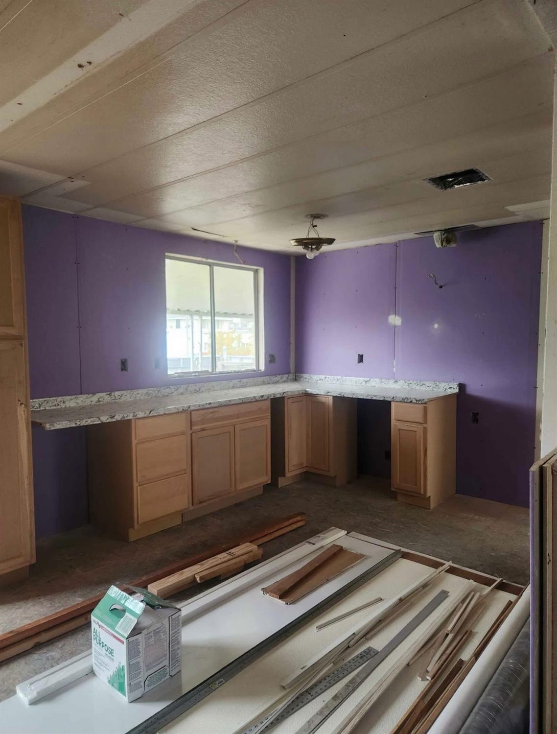 2809 North Buhach Road, Unit 89 Atwater, CA 95301 - Photo 3 of 6 a kitchen with stainless steel appliances kitchen island granite countertop a stove a sink and a microwave