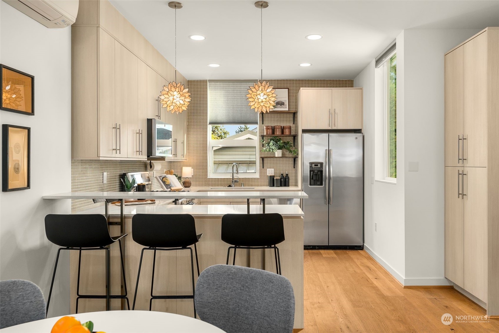 3909 Southwest Findlay Street Seattle, WA 98136 - Photo 14 of 32 a kitchen with stainless steel appliances granite countertop a dining table chairs sink and cabinets