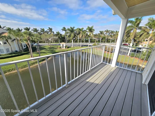 a view of a balcony with wooden floor and fence